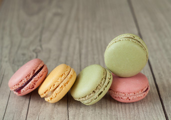 Colorful macaroons over turquoise wood backround