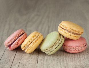 Colorful macaroons over turquoise wood backround