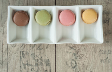 Colorful macaroons over turquoise wood backround