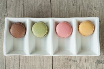 Colorful macaroons over turquoise wood backround