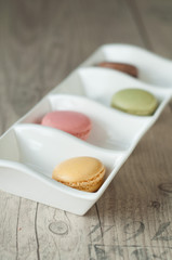 Colorful macaroons over turquoise wood backround