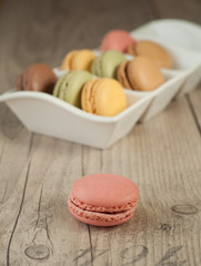 Colorful macaroons over turquoise wood backround