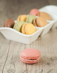 Colorful macaroons over turquoise wood backround
