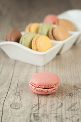 Colorful macaroons over turquoise wood backround