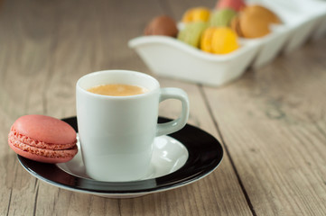 Colorful macaroons over turquoise wood backround