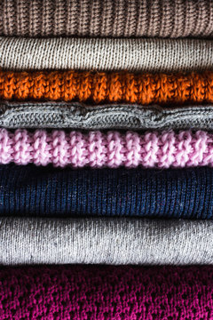 Stack of colors cozy knitted sweaters