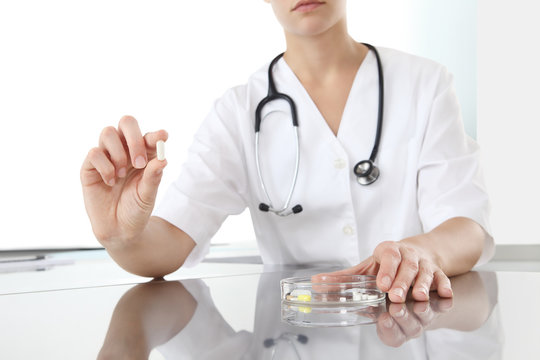 Doctor holding pill medicine close up. Health care and medical concept