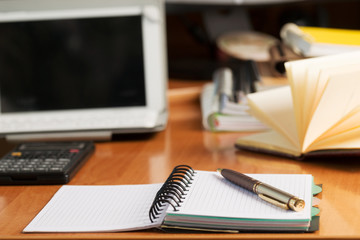 Office desk table with computer, calculator, supplies. Copy space for text