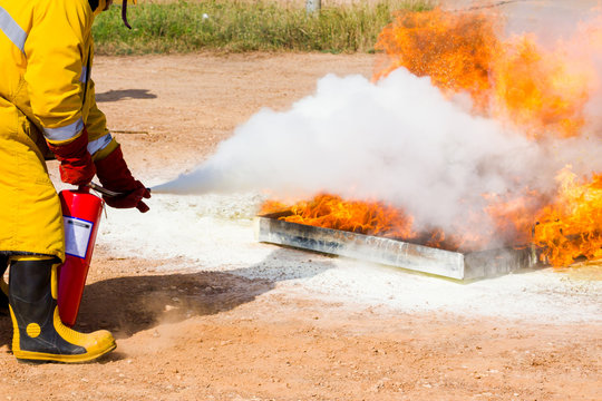 Fireman showing how to use a fire sprinklers. on a training fire
