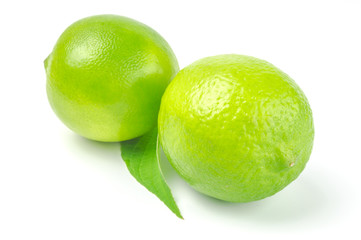 Two lime with leaf isolated on white background