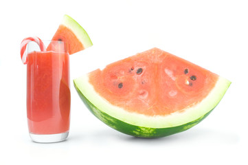 Glass of watermelon juice and slices on white