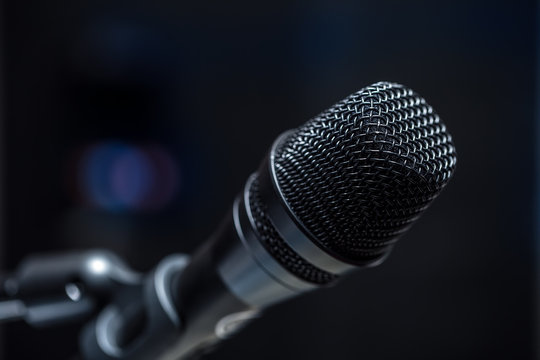 Close-up of microphone in  conference room or concert hall.