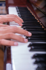 Fototapeta na wymiar Man playing piano with both hands portrait view 2