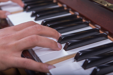 Fototapeta premium Man playing piano with both hands side view closeup 2