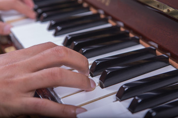 Fototapeta premium Man playingpiano with both hands side view closeup 3