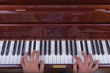 Man playing piano with both hands