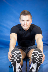 Muscular young man exercising in his fitness gym; close-up (colo
