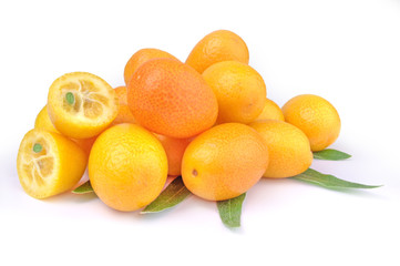 Pile of kumquat and two its half isolated on white background with leaves