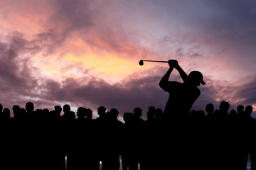Naklejka na ściany i meble Golfer playing golf during sunset at competition event