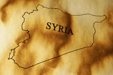 Syria map on a charred paper. Syrian conflict concept