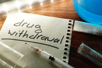 Drug withdrawal written on a paper.  Addiction concept.