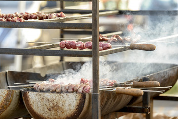 skewers of meat on the outdoor grill