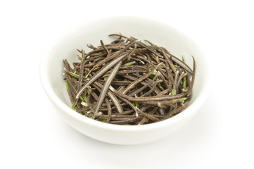Dry leaves rosemary in plate isolated on white background cutout