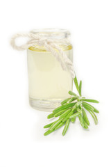 Rosemary oil and fresh herbs on white background