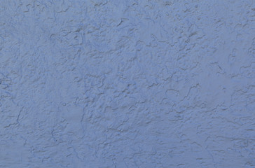Blue stucco wall forms an irregular pattern that can be used for backgrounds.