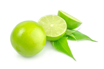 Two halves and whole lime with leaf isolated on white