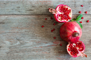 Ripe pomegranate fruit on wooden rustic background