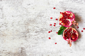 juicy pomegranate fruit on white wooden rustic background