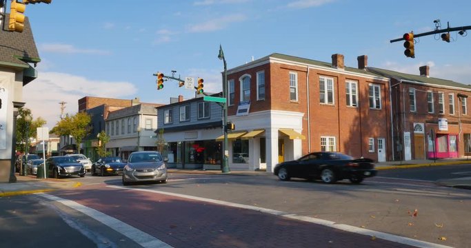 A daytime establishing shot of businesses on a typical Main Street in America. Pittsburgh suburb.	 	