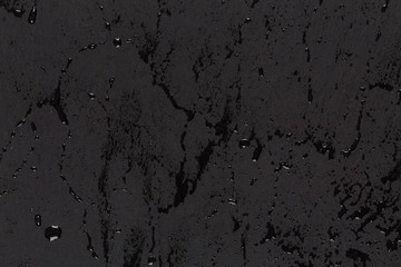 Water drops on dark stone surface