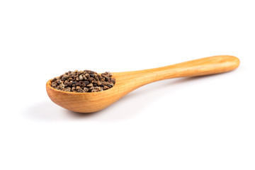 Decorticated cardamom seeds in a wooden spoon