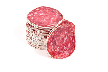 Slices of salami sausage on a white background