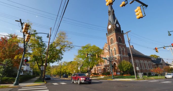A tilt up establishing shot of an intersection and church in a typical American small town. Pittsburgh suburb.  	