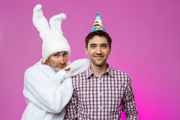 Drunk man and rabbit at birthday party over purple background.