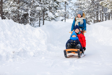 Fototapeta na wymiar Mother and kids outdoors on winter