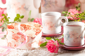 Valentine day background, two cups, pink roses, gift box
