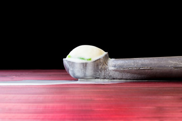 ice cream scoop melting. business gradually fall concept on red wood background.