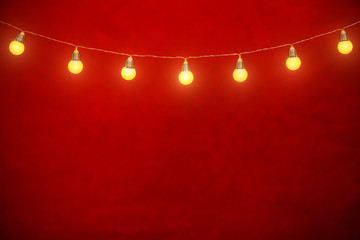 Hanging bulbs on rope with red background