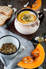 Creamy pumpkin cream soup with pumpkin sunflower seeds and olive oil
