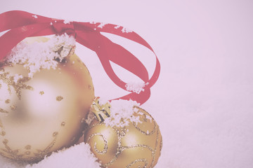 Gold Christmas decorations in white snow for background Vintage