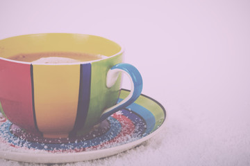 Hot chocolate in a bright colourful cup Vintage Retro Filter.