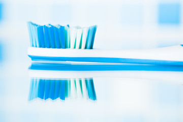 blue toothbrush in a bathroom with reflection