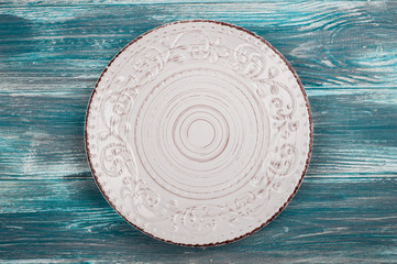 Empty plate over wooden table