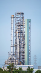 Oil refinery along daytime with blue sky
