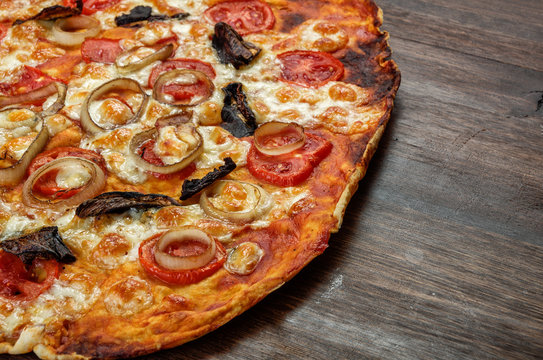 Part of pizza with mushrooms and mozzarella on wood background