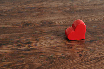 Valentines day. A red heart isolated on a wooden background